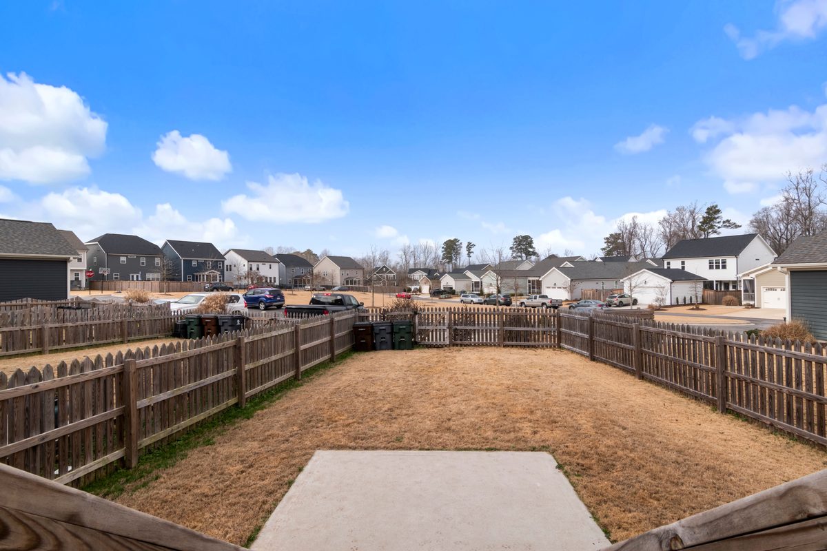 Six-foot dog-ear privacy fence of treated pine in a back yard