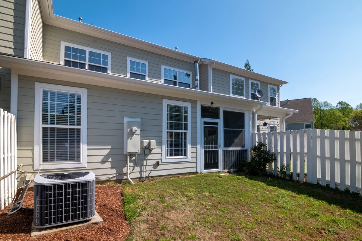 White vinyl privacy fence along a lawn